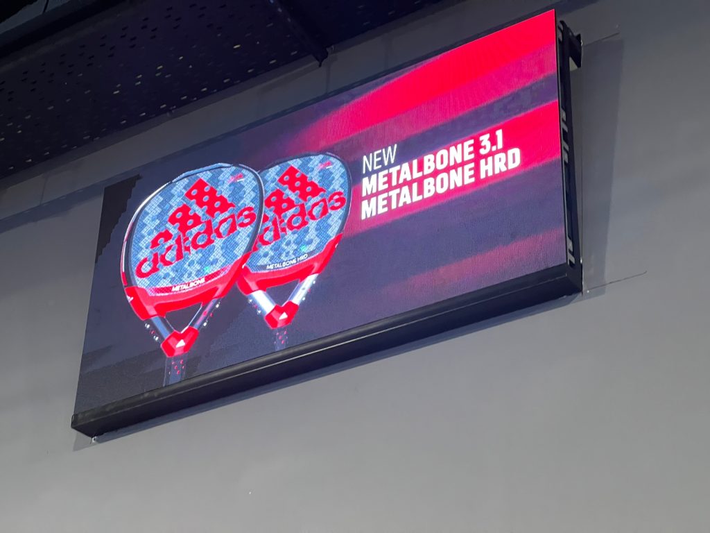 Wall-mounted LED screen displaying sports-product advertising