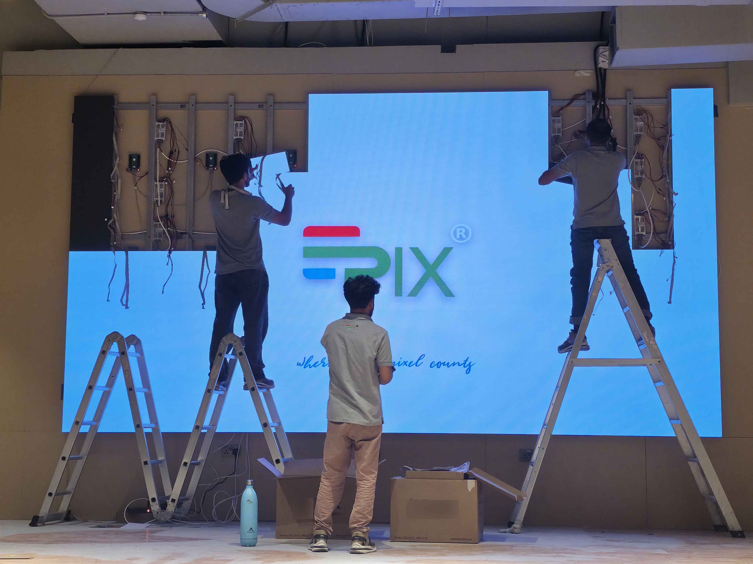 LED module fixing by Epix team during MyPT gym LED screen installation in Abu Dhabi